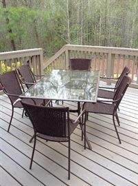 Outdoor glass top dining table & 6 woven chairs