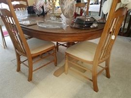 Dining table and chairs (4) Solid piece in mint condition. 1 leaf, table cover $230