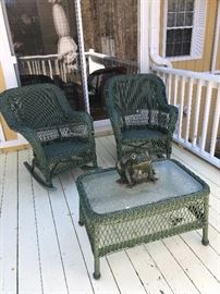 Two green wicker chairs, table and frog planter