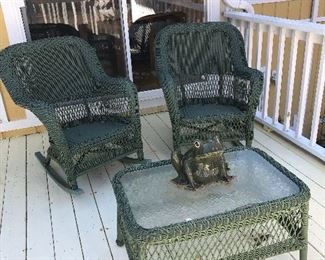 Two green wicker chairs, table and frog planter