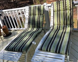 Two lounging chairs with cushions