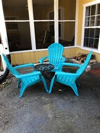 Blue plastic Adirondack style chairs and table