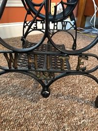 White sewing machine base with glass top. Makes a great table!
