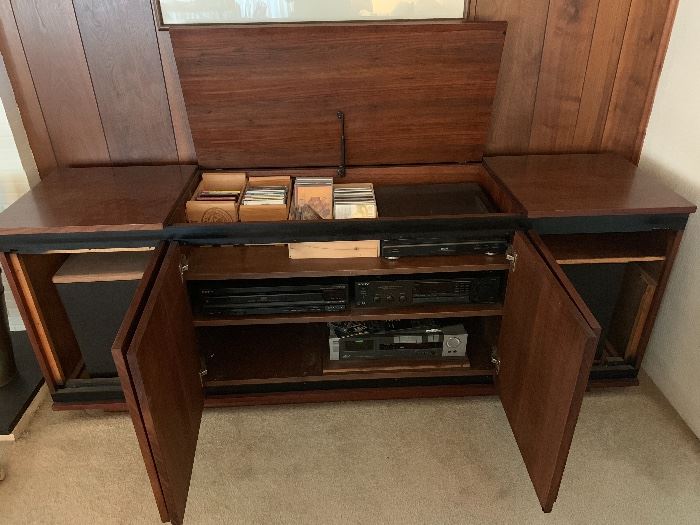 Mid Century Modern hi-fi stereo cabinet with one lift top cabinet and three cabinet doors below on the front
