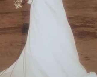 Beautiful boxed wedding gown with lace detail. Ladies size 4.