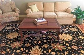 Large rug approx 14x9, upholstered arm chair by Pembrook Chair Corp., sofa from Rich's, large square Wellington Hall coffee table with leather inlay and claw feet, planter