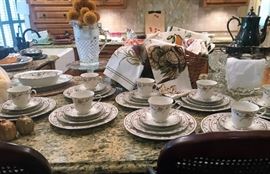 Five-piece place settings of Noritake Ivory China in “Adagio” pattern w/serving pieces, Silverplate Tea service, Glass pitcher, barstools, kitchen linens, more