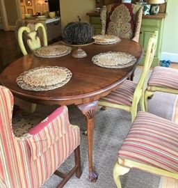 Table with four chairs, 2 matching upholstered wing-back chairs, decorative centerpiece, rug, more