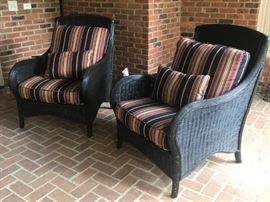 Black wicker chairs w/cushions.