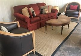 Two black chairs, area rug, red sofa, folding table, more