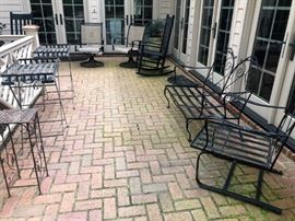 2 metal outdoor tray stands, love seat, chair, 2 of 4 black wooden rockers and other outdoor chairs.