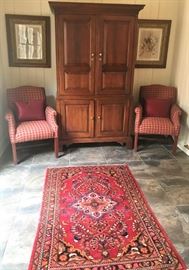 Pair of red plaid arm chairs, Large entertainment armoire, Vintage framed Saron bird prints, handwoven rug