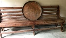 Long wooden bench and large copper tray