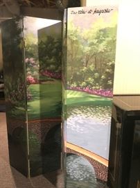 Painted scene of the 12th hole at Augusta on a wooden room screen.