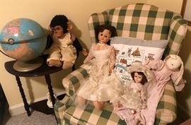 Upholstered green plaid arm chair, half-round table, vintage dolls, vintage Cram's globe