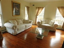 formal living room set with stone and glass coffee tables 