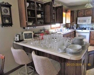 2 Kitchen's in this LARGE Home... Bar Stools, Glassware, Corning Ware, Pyrex, Glassware, Dishes, Pots/Pans, Small Appliances, Microwave, TV, Toaster, Collection of Clock's located t/o the home.