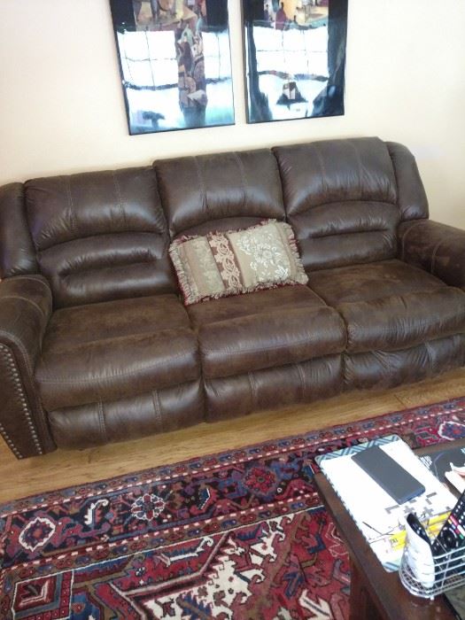2 brown leather recliner sofas.