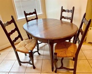 French Provincial table and 4 Ladder back rush chairs.  (Leaves available for table)