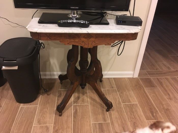 A wonderful example of a Victorian marble-topped lamp table.