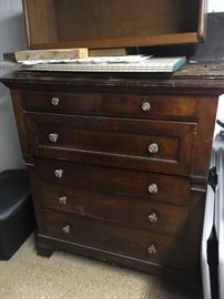 . . . a nice pine chest of drawers with glass knobs.