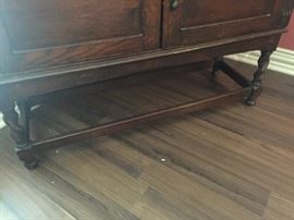 The barley twist detail of the lead glass china cupboard