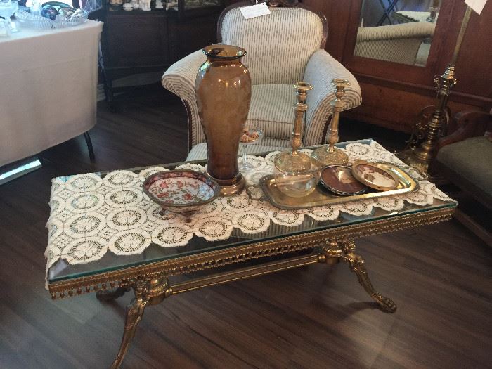 Very ornate coffee table, brass pieces, art work and glass