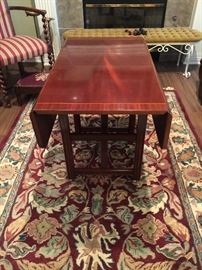This is a very unusual table.  It is adjustable, can be lowered it is a coffee table and at the height showing becomes a tea or card table with two drop leaves