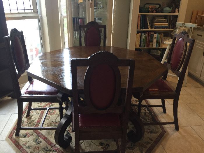 This table is in the Kitchen and is eight sided, with two leaves. Eight sided wool rug.  The chairs are separate.