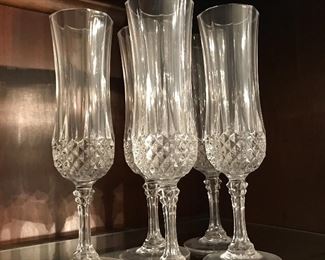 Five crystal champagne flutes, unmarked.