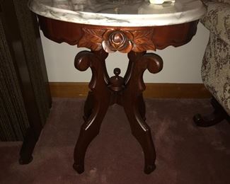 Close up of round table carved floral design.