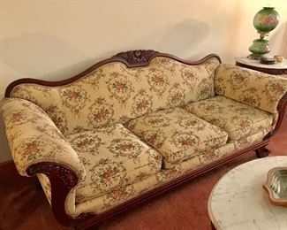 Lovely vintage sofa with carved wood trim. Center back fruit motif is repeated on each side of the sofa.