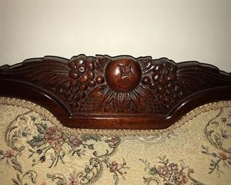 Lovely vintage sofa with carved wood trim. Center back fruit motif is repeated on each side of the sofa.