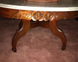 Closeup of carved floral design on coffee table.