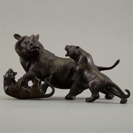 Japanese Meiji period cast bronze figural group of two tigers attacking a rhino. The animals are done with incredible detail. The bronze is signed Genryusai Seiya. Dimensions: Height: 5 in x width: 7 1/2 in x depth: 4 in.
