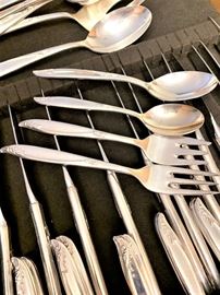 Holmes & Edwards deep silver (silverplated) flatware set.  In very good vintage condition with normal wear. Includes 25 teaspoons, 12 tablespoons, 16 luncheon forks, 8 salad forks, 12 knives, 1 master butter, 1 casserole spoon, 1 slotted spoon, 1 serving spoon, 1 serving fork, 1 cake server. 