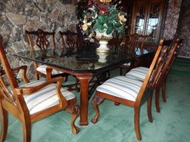 Thomasville Glass top table with 6 chairs ,carved claw and ball feet.