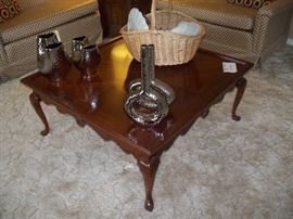 large square coffee table.  Silver accent pieces.  Basket of Imari dishes