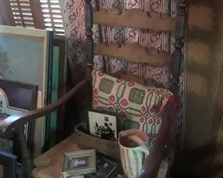 Arm chair with rush seat, elaborately carved back slats; framef silhouettes, woven pillows, pottery pitcher
