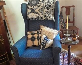 Wing chair, pillows, hand-woven coverlet