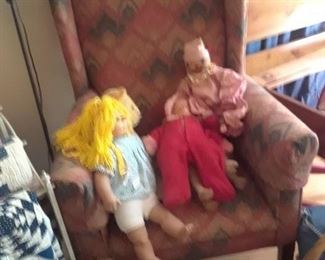 Dolls and upholstered wing chair