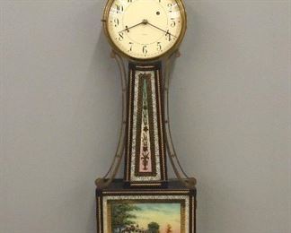 A 1930's Waltham Banjo clock.  With an 8-day weight driven time-only movement.