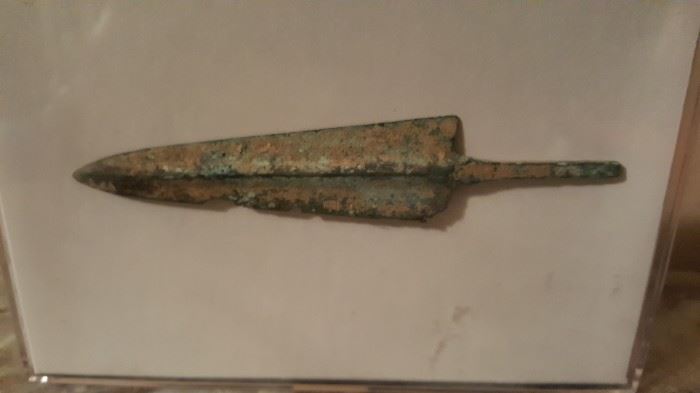 EARLY PERIOD AND ORIGINAL, CIRCA. 50-100 A.D., BRONZE COMPOSITION, PILLUM TYPE OF SPEAR HEAD. THIS SCARCE BATTLE IMPLEMENT DISPLAYS NEARLY ALL OF ITS ORIGINAL DETAIL AND FORM. IT IS PRESENTED IN A VF (VERY FINE) STATE OF PRESERVATION. Excavated by German  archaeologists  inside the old Roman walled city of Lugo, Galicia, Spain. In 13 BC on the positioning of a Roman Legion military camp, while the Roman Empire completed the conquest, in the North, of the Iberian Peninsula Situated in what was the Roman Province of Hispania Tarraconensis, it was the chief town of the tribe of the Capori. Though small it was the most important Roman town in what became Gallaecia  during the Roman period, the seat of a conventus, one of three in Gallaecia, and later became one of the two capitals of Gallaecia, and gave its name to the Callaïci Lucenses. It was centrally situated in a large gold mining region, which during the Roman period was very active. Today this Roman city is called Lugo in Galicia, S