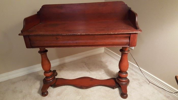 This gorgeous Antique Spanish Colonial desk is crafted from beautiful Cuban mahogany and it is finished on all sides so that it can stand freely in the middle of a room. The desk has one large useful drawer and has an elegant tall gallery around the sides and around the rear of the top. Cuban mahogany was so sought after, that by the late 1850s, this particular variety became all but extinct. A beautiful and rich writing desk that it demands the attention of the room. From the mid 1800's this item is still in extremely great condition and would be a value add to any collection.