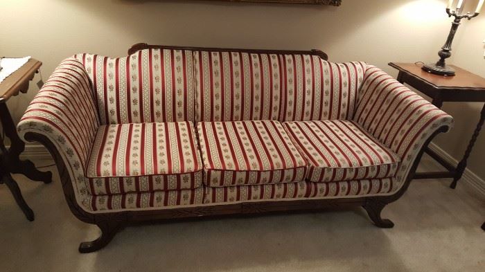 Stunning Antique Queen Anne Style Camel back Parlor Sofa. This sofa features a cream, burgundy and gold striped upholstery with rolled arms.   In excellent condition.