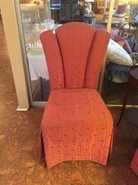 One of four armless upholstered chairs