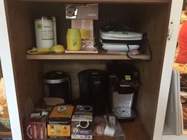 Coffee grinder, Sunbeam vintage electric can opener, single cup coffee makers, George Foreman grill, Kuerig coffee maker, Kuerig cups