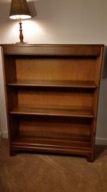 This bookcase is jointed and is a Mid-Century beauty
