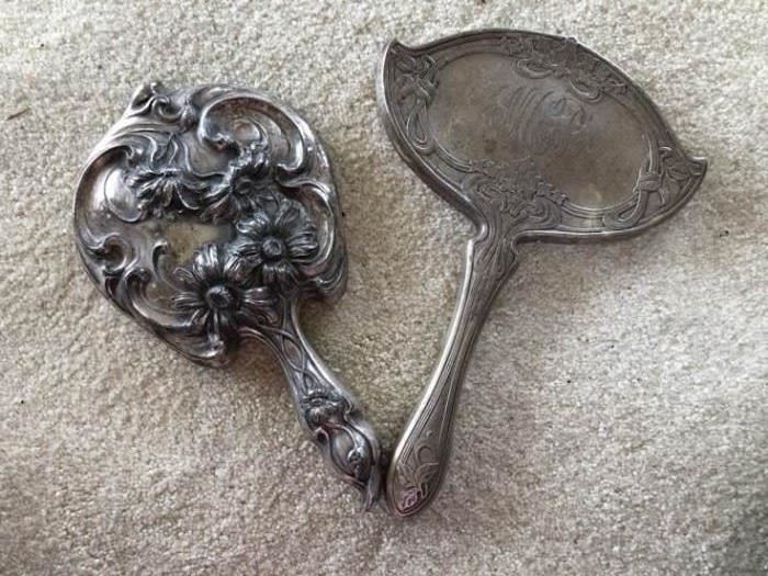 Sterling silver hand mirror and a silver plated and mirror