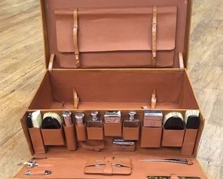 Vintage leather suitcase & toiletries. Low estimate $350